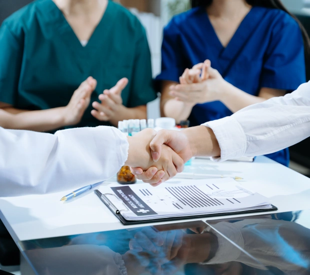 Healthcare professionals reviewing insurance contracts